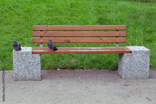 Wooden bench rests on stone bases