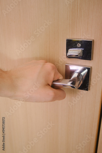 A hand opening a door