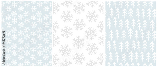 Simple Hand‑Drawn Seamless Vector Patterns - Winter Snowflakes and Pine Tree Repeats. Christmas Pattern With White and Light Gray Snowflakes On a Pastel Blue And White Background. White Trees On Blue.