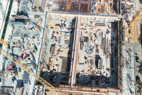 Drone aerial view of active construction site with cranes in Miami Beach urban development area