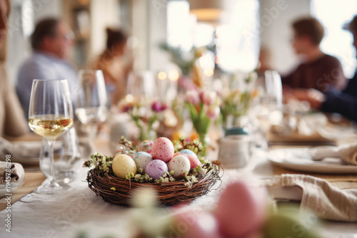 Happy family having Easter dinner together, table setting with traditional food, colorful eggs and spring flowers for Easter celebration	
