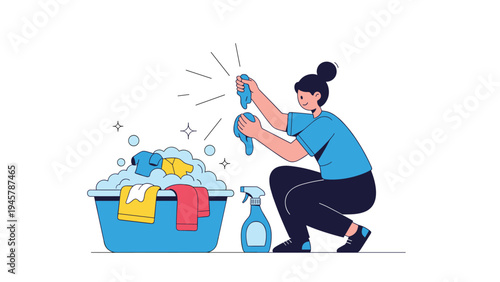 Young woman squatting and washing clothes by hand in a blue plastic tub with soapy suds and a spray bottle on the floor nearby.