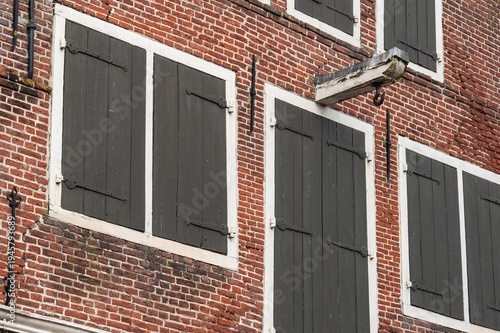 Traditional dutch brick facade with closed shutters