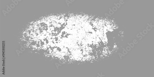 Textured abstract pattern of white speckles and irregular shapes on a solid gray background