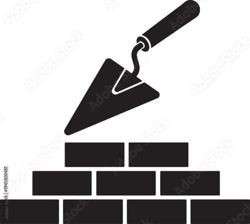 Trowel placing a brick on a black wall also transparent background construction building