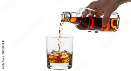 Hand pouring whiskey into a glass with ice cubes isolated on transparent background