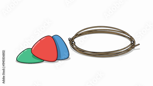 Three colorful guitar picks and a coiled set of strings