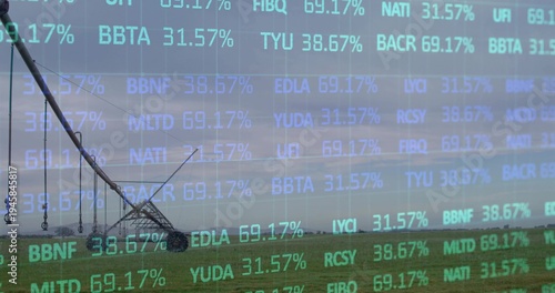 Stretching center-pivot irrigation system moving across rural field to horizon, with cyan overlay