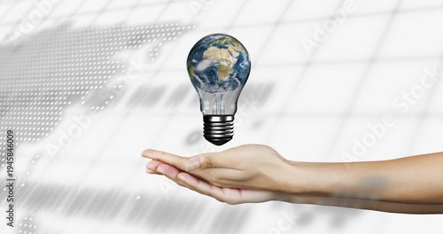 Holding bare right arm and hand presenting levitating bulb with Earth above palm, studio map left