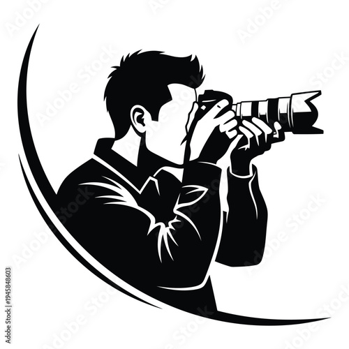 Man holding a professional camera with a large lens and spider logo on shirt