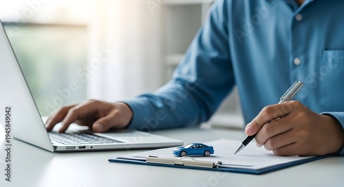 Businessman working with laptop and documents with car model on desk, symbolizing car loan, vehicle insurance, financial contract, and automobile business investment. 
