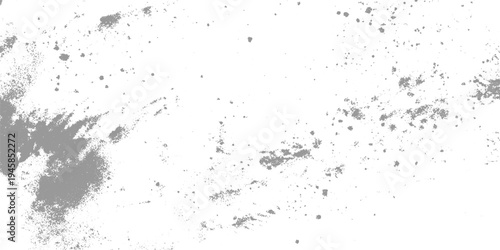 Scattered gray dust particles and smudges on a white background