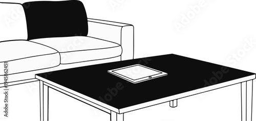 A black cushion on a white couch sits beside a table with a tablet
