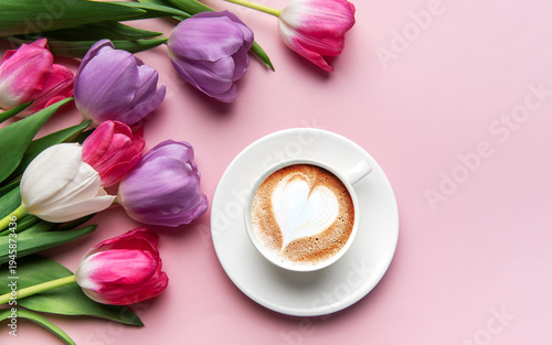 Tulips and coffee with latte art heart on pink background