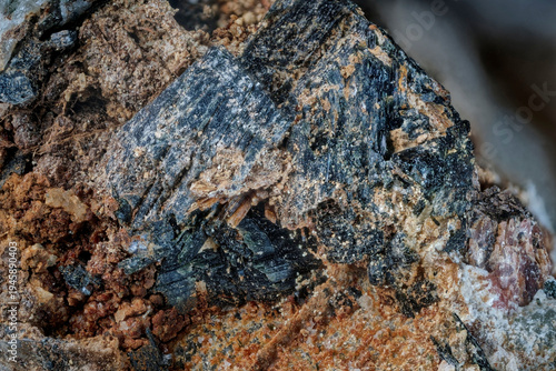 Macro image of weathered rock with aegirine, eudialyte and titanium-bearing silicate from the Analcime Gorge area near Aykuayvenchorr Mt., Khibiny captured via microscope objective at 4× magnification
