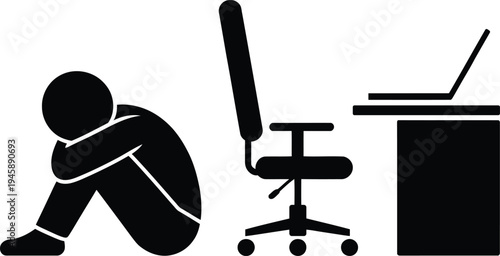 Person sitting on the floor next to an office desk and chair.