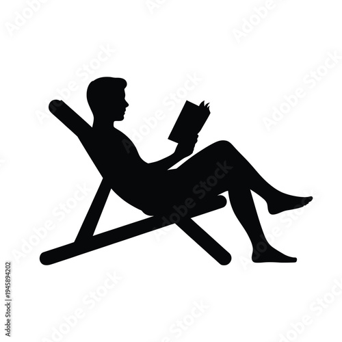 Silhouette of a man relaxing in a deck chair reading a book