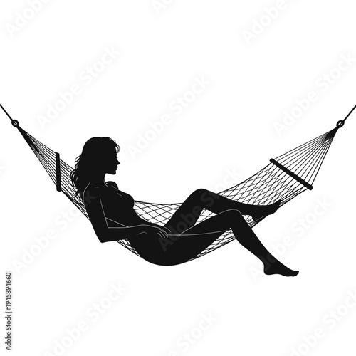 Silhouette of a woman relaxing in a woven hammock outdoors