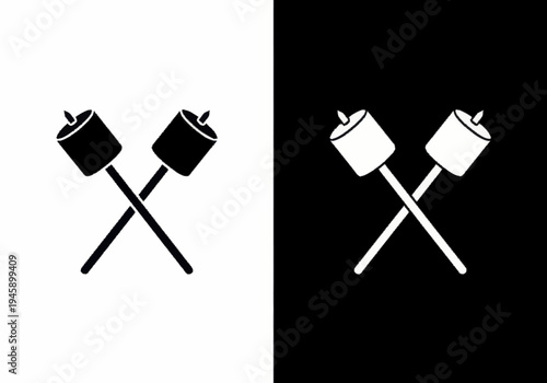 Marshmallows on skewers are toasting over fire in the night.