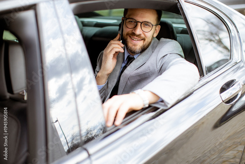 Businessman talks on phone ...