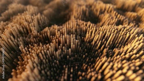 Abstract textured background in warm golden tones, undulating surface with a forest of vertical elements moving