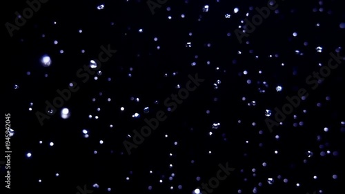 Sparkling diamond fragments floating in darkness with bright blue light flares and bokeh effect