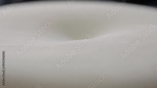 White foam texture distortion slowly reveals deep dark hollow center abstract slow motion