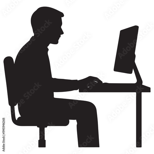 Silhouette of a man working on a computer at a desk, focused on his task.