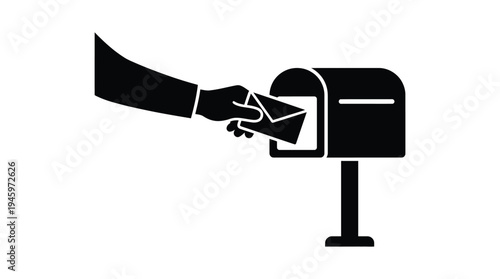 Black hand inserting envelope into mailbox letter