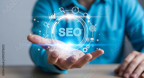 Hand holding glowing SEO text with digital marketing icons, symbolizing search engine optimization, online strategy, and future business innovation
