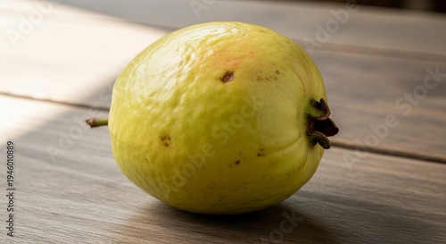 Single Guava Image of Single Yellow Green Tropical Fruit with Stem and Natural Texture on Rustic Wooden Surface