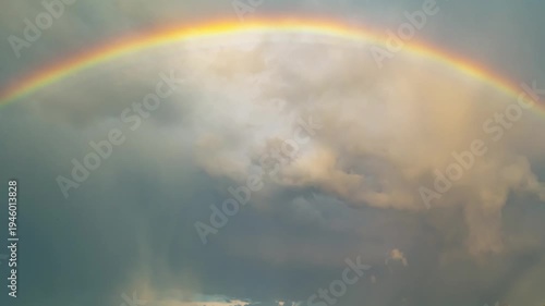 Rainbow glows softly in the sky. Rainbow arcs across gentle clouds. Rainbow brings calm after rain. Rainbow shines with quiet hope.