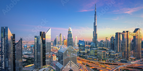Panoramic skyline of Dubai with modern skyscrapers and futuristic architecture at sunset. Iconic cityscape of the largest city in the United Arab Emirates, famous for luxury tourism, business district
