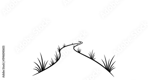 Winding road through grassy hillside landscape