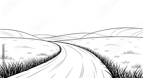 Winding road through rolling hills and grassy fields
