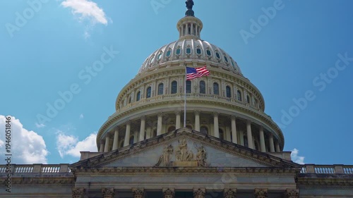Capitol monument under sky. Patriotic capitol with American flag. Historic capitol facade closeup. Federal capitol in Washington DC.