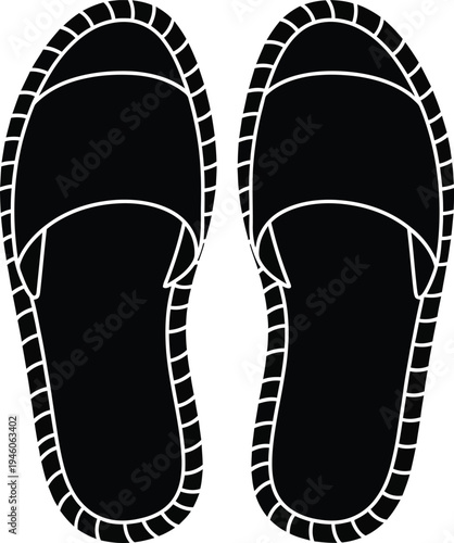 A pair of black traditional espadrilles with white stitching detail seen from a top view