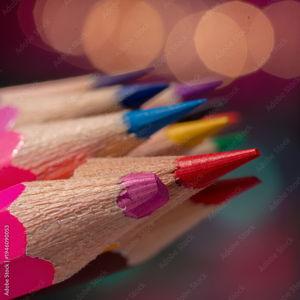 Obraz premium A vibrant, close-up macro shot of sharpened colored pencils with dramatic bokeh light ai illustration 
