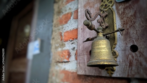 Bild auf Leinwand Antique brass bell hanging on an old brick wall, rustic decor