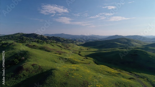 Expansive Green Rolling Hills with Valley and Distant Mountains
