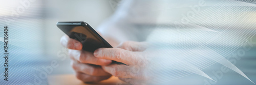 Hands using mobile phone; panoramic banner