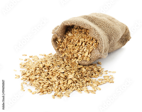 Photos Uncooked oat flakes in sack isolated on white