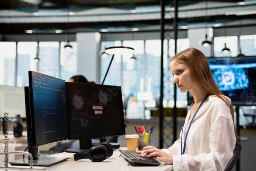 Fotografie Young inexperienced programmer in office struggling to fix critical error warning popup