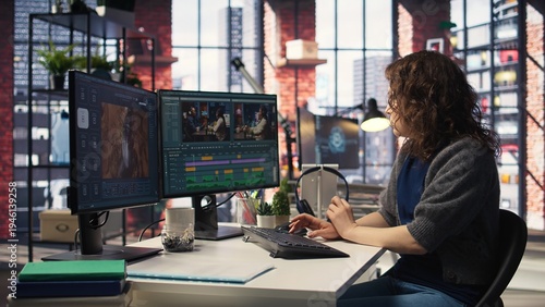 Tableau sur toile Filmmaker working on media post production from agency office, ensuring the editing timeline and color correction for a video shoot