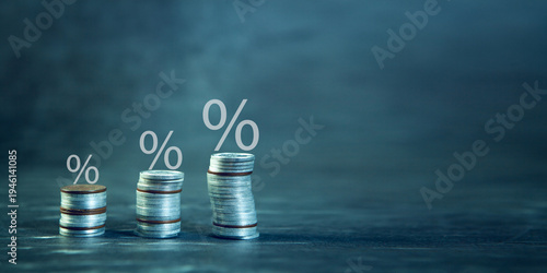 Coins stacks with percentage sign on dark background. Finance and banking concept.