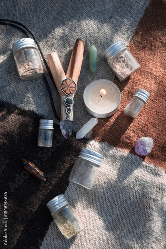Obraz na plátně A traditional wooden kuripe pipe decorated with crystals alongside small glass vials of Rapé powder and healing stones