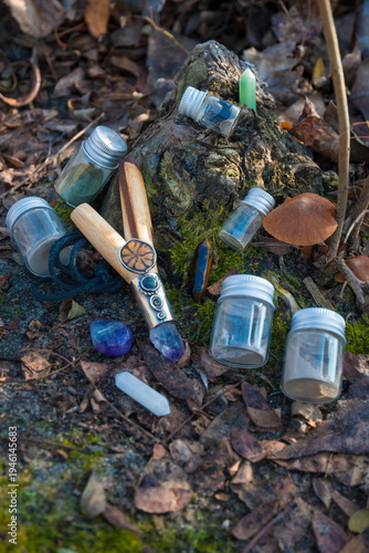 фотографія A traditional wooden kuripe pipe decorated with crystals alongside small glass vials of Rapé powder and healing stones