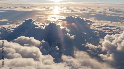 Aerial 4K cinematic footage of dramatic clouds at sunrise with golden sunlight breaking through