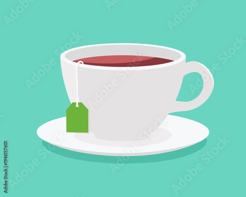 A white teacup filled with dark tea and a green tea bag