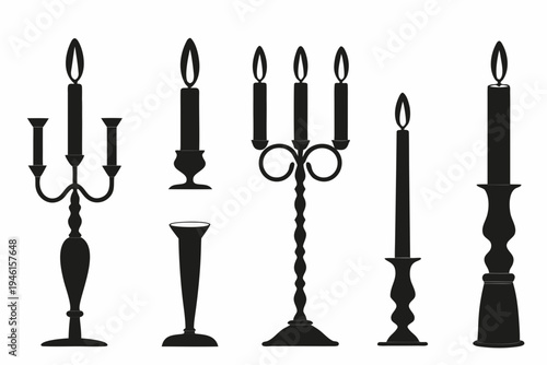 A collection of black silhouette candles and ornate candleholders